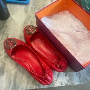 Tory Burch bright red with gold detail. Size 11 runs smaller per TB style